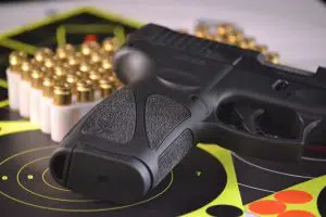 Taurus G3 9mm pistol with targets and bullets in the background