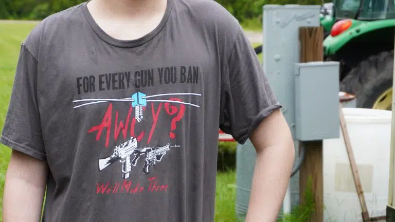 A member of AWCY? (Are We Cool Yet) wears the group's shirt at the Gun Makers Match