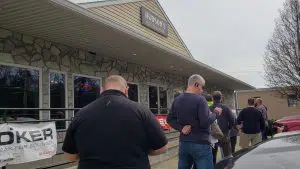 Customers wait in line outside of Hudson's Outfitters & Firearms in Pottstown, Pennsylvania on March 18, 2020