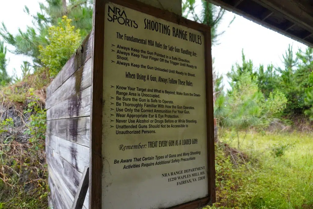 A sign details the rules at an outdoor shooting range