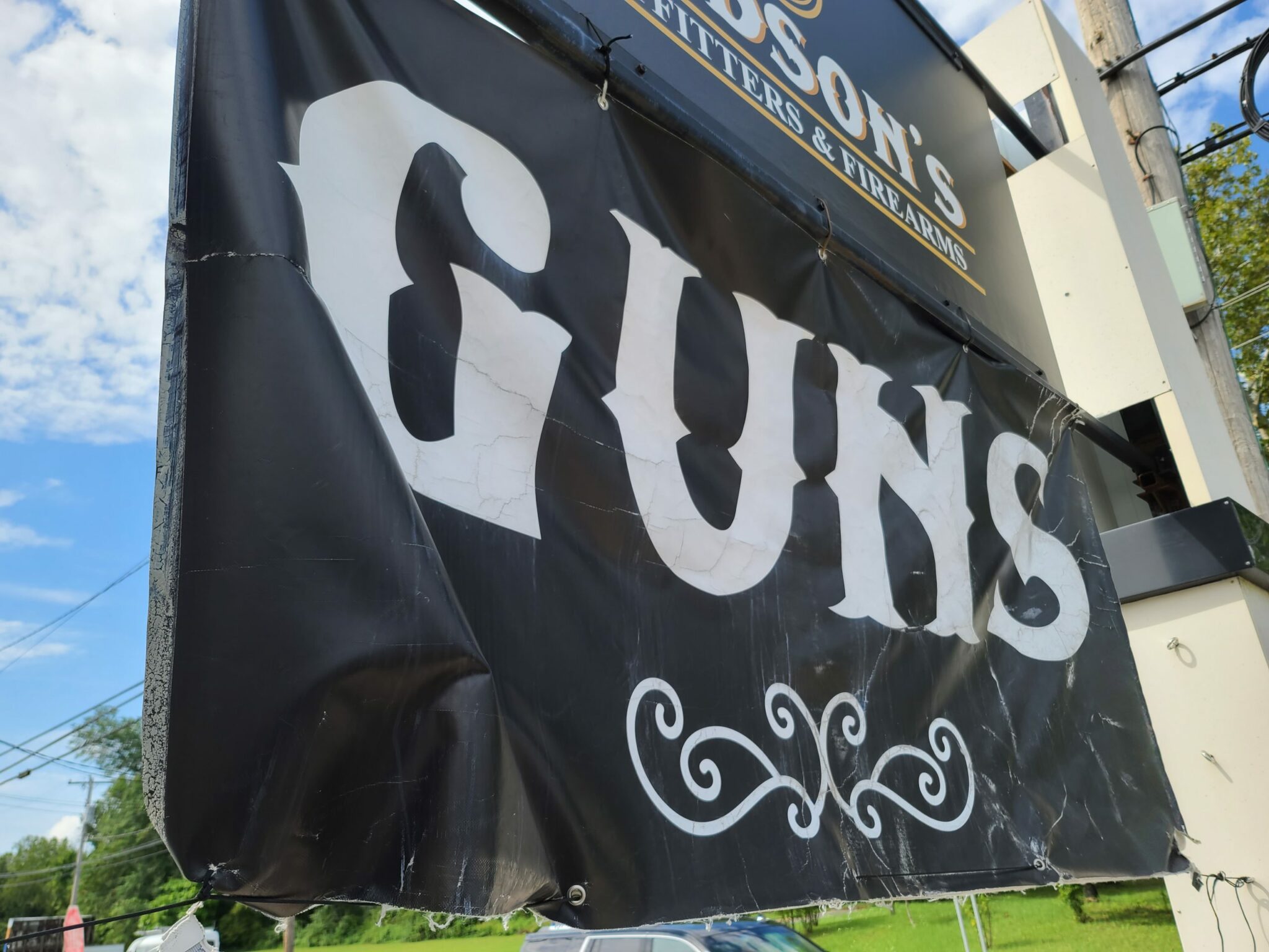A sign advertising guns outside a store