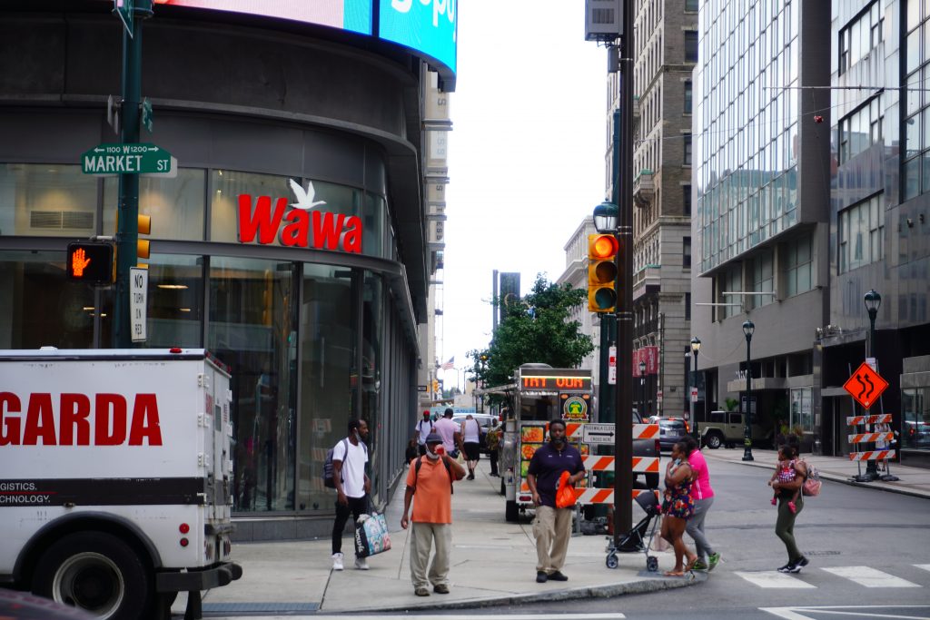 Pedestrians walk past a Wawa on Market Street in Philadelphia, Pennsylvania