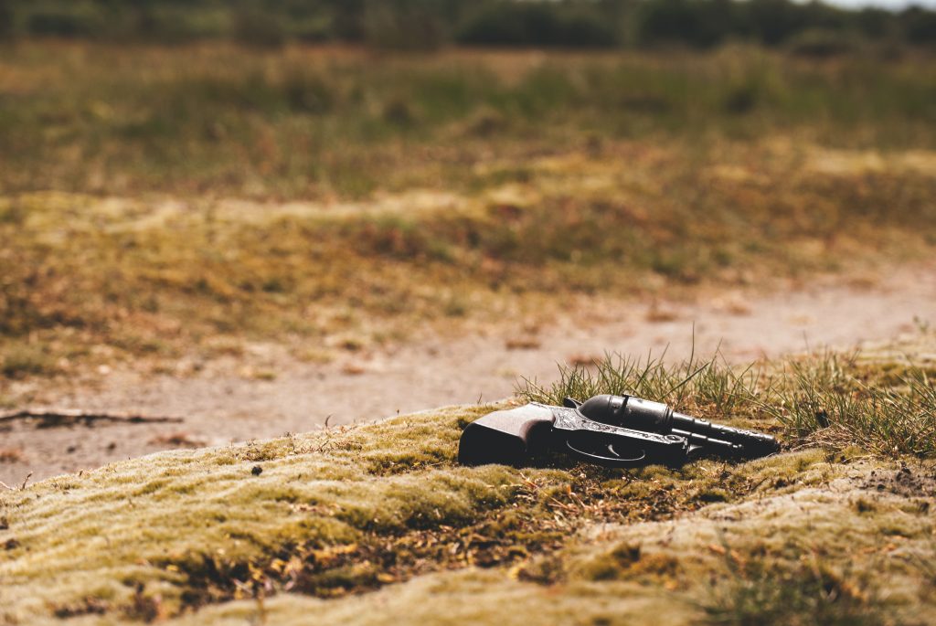 black revolver pistol on ground during daytime