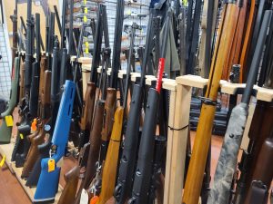 Guns displayed on a rack at a gun store
