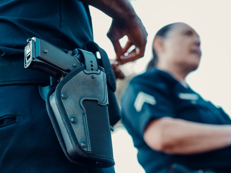 A police officer and a holstered handgun