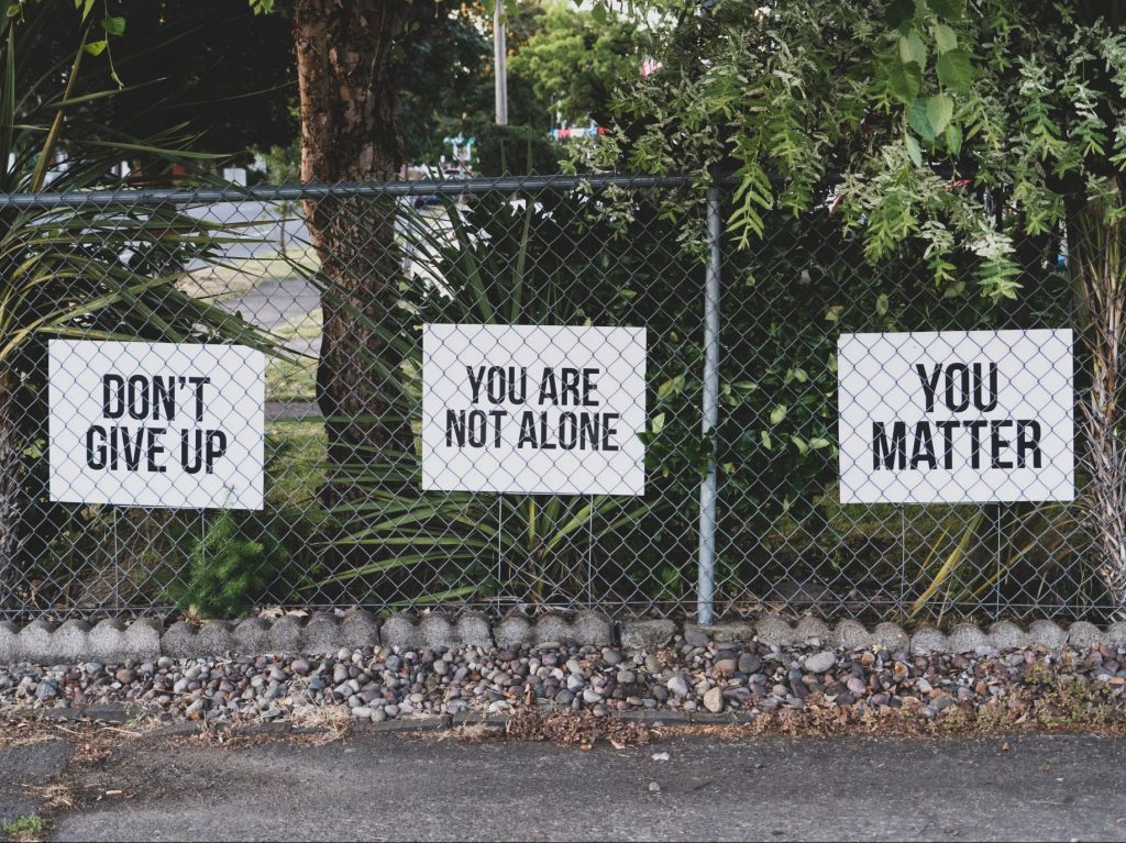 Suicide prevention signs displayed on a fence