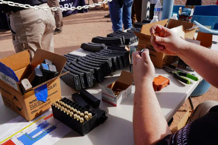A man loads ammunition magazines during range day at SHOT Show 2022