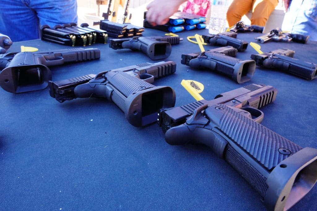 A collection of handguns from Rock Island Armory are prepared for shooting during a demonstration at SHOT Show 2022