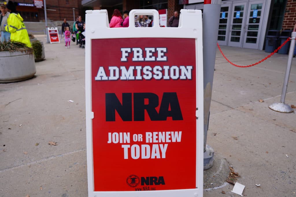 A sign offering free admission to the 2022 Great American Outdoor Show for those who buy an NRA membership