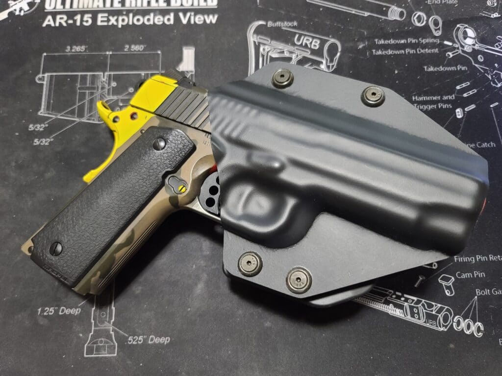 A 1911 pistol holstered in a kydex holster