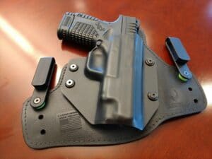 A holstered Springfield XDS sits on a table
