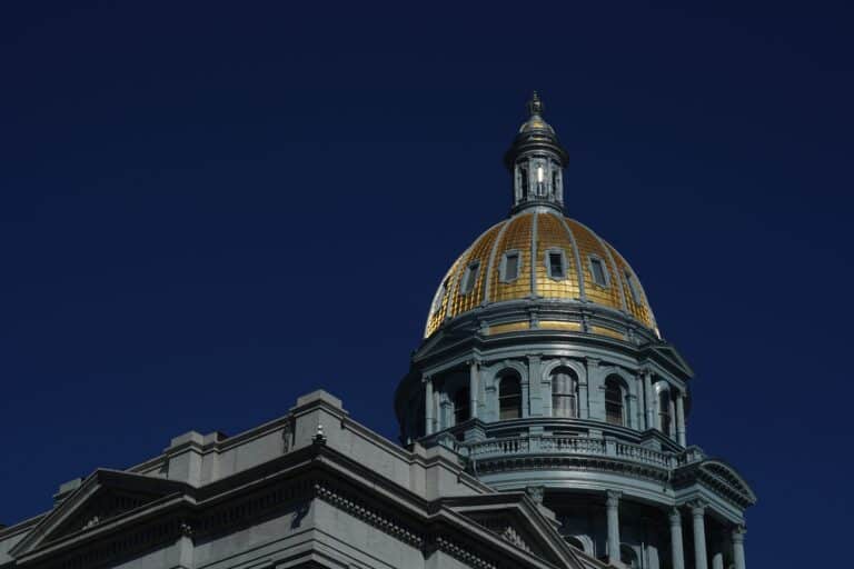 Colorado state Capitol. Gold dome against a deep blue sky.