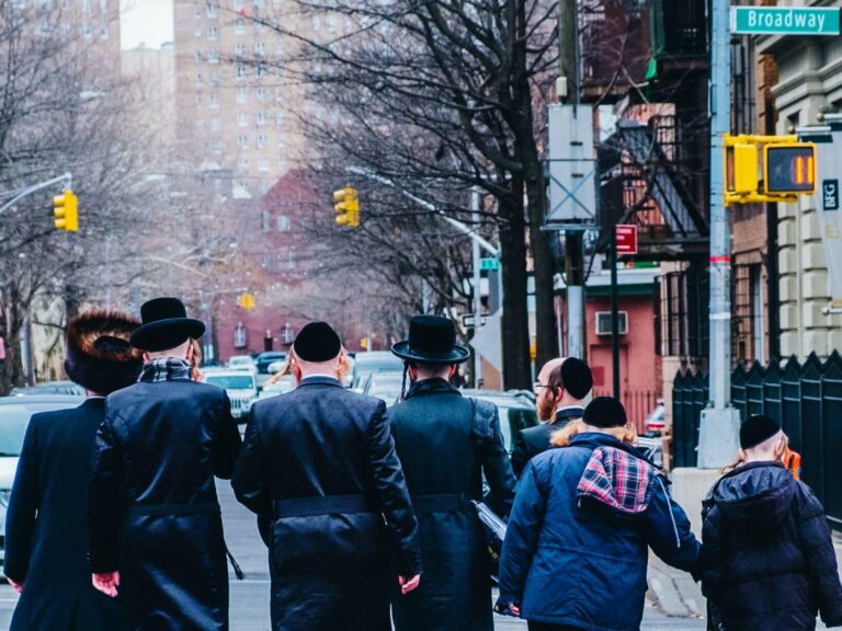 A group of Orthodox Jewish people walk in New York City