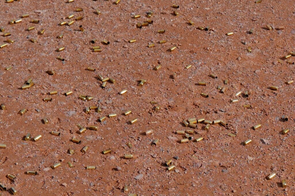 Spent shell casings cover the ground at an outdoor range during the 2023 SHOT Show in Las Vegas, Nevada