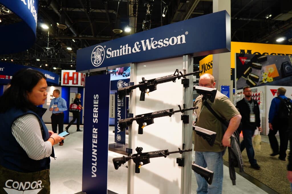 Attendees examine Smith & Wesson AR-15s during Shot Show 2023 in Las Vegas, Nevada