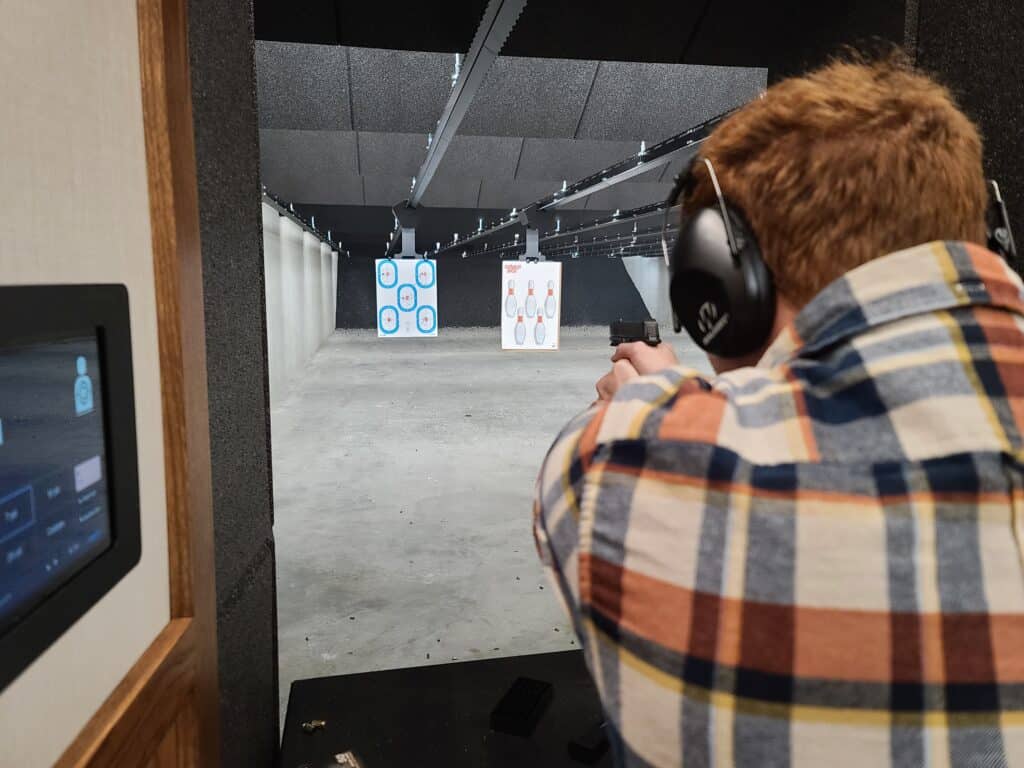 A shooter takes aim at a paper target in a Pennsylvania gun range during April 2023
