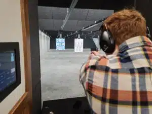 A shooter takes aim at a paper target in a Pennsylvania gun range during April 2023