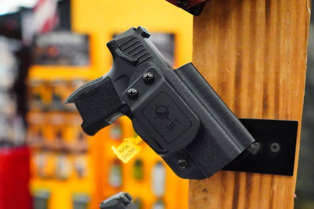 A holstered handgun on display at the 2023 NRA Annual Meeting