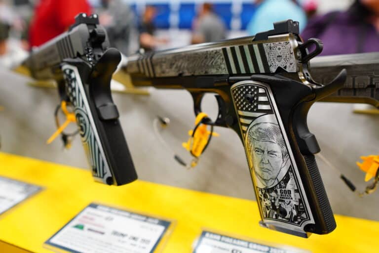 A pistol with former president Donald Trump's face engraved in it on display at the 2023 NRA Annual Meeting