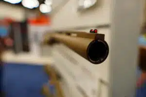 The muzzle of a shotgun barrel on display at the 2023 NRA Annual Meeting