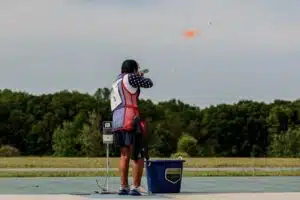 Matthew Kutz breaks a clay target as it flies through the air