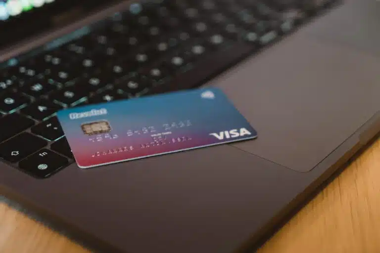 A credit card sits on a laptop