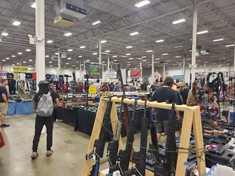 Customers browse guns at the Nation's Gun Show in July 2023