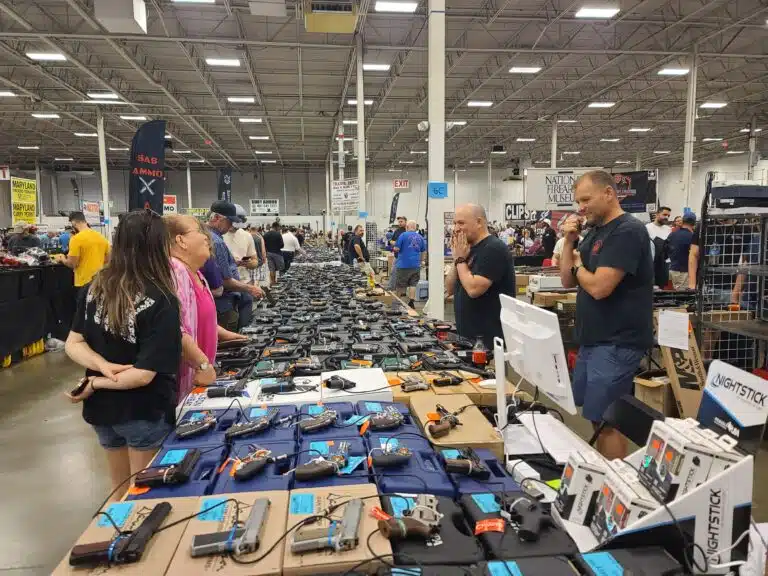 Customers examine handguns on sale at a Virginia gun show in July 2023