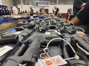 Pistols laid out for sale at a gun show booth in Virginia during July 2023