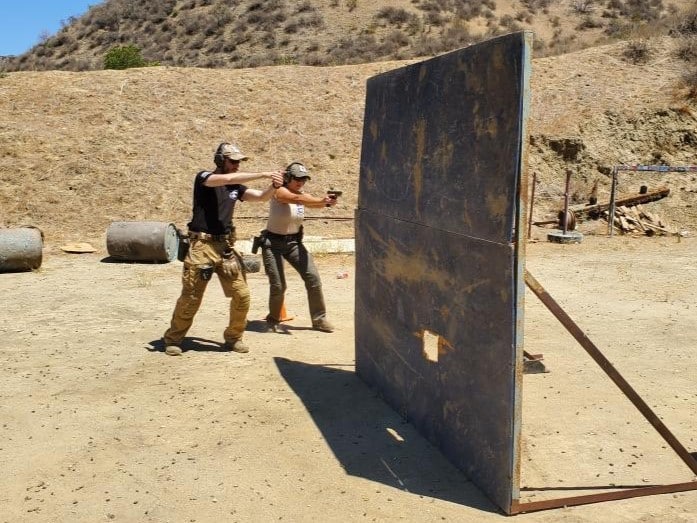 A Magen Am firearms instructor teaches a student how to round a corner in training