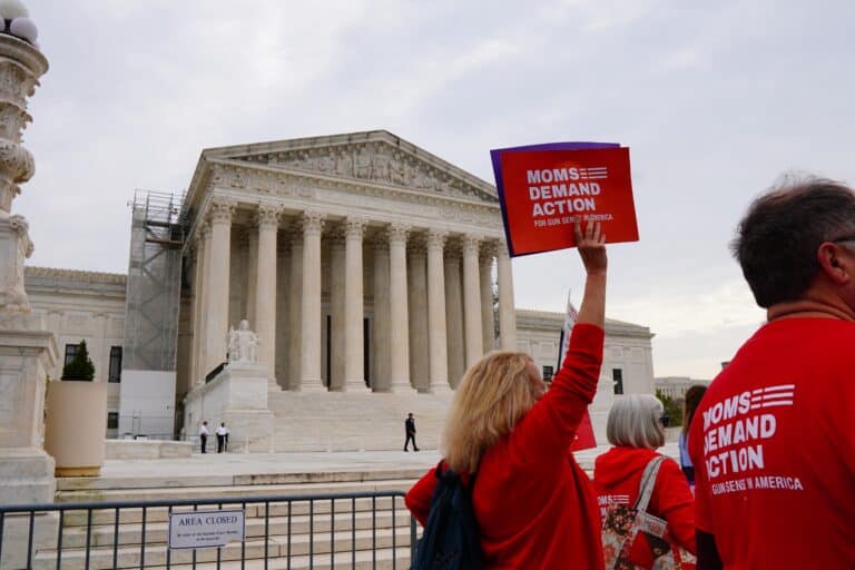 A Moms Demand Action supporter holds a sign outside the Supreme Court