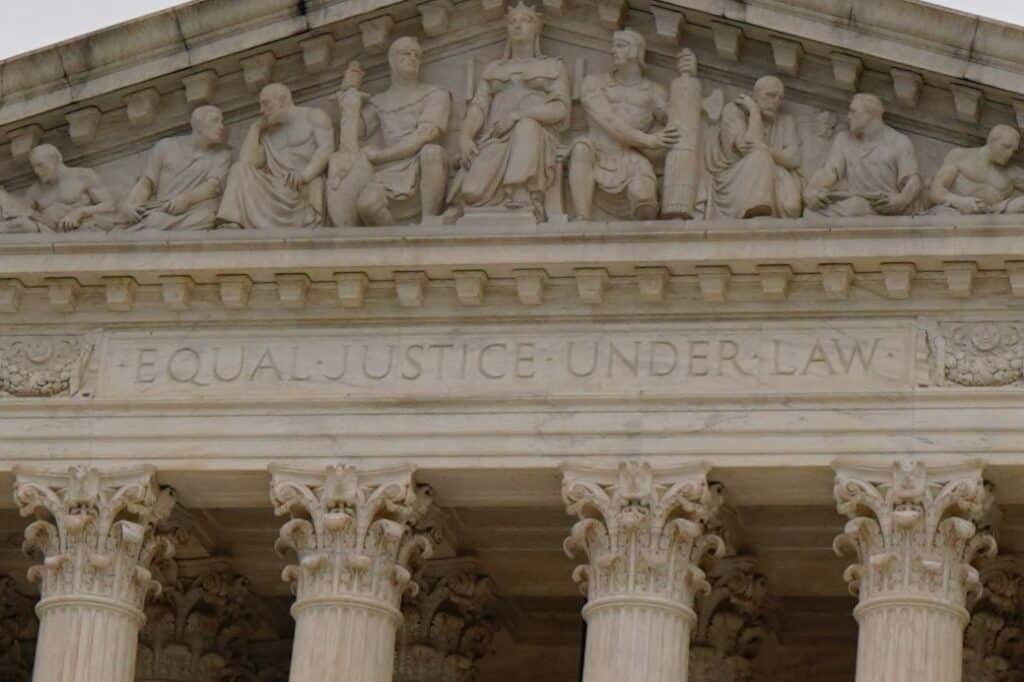 A closeup of the moto on the face of the Supreme Court