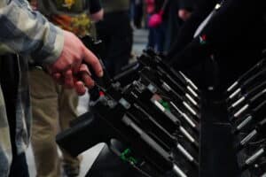An attendee examines a pistol optic at SHOT Show 2024