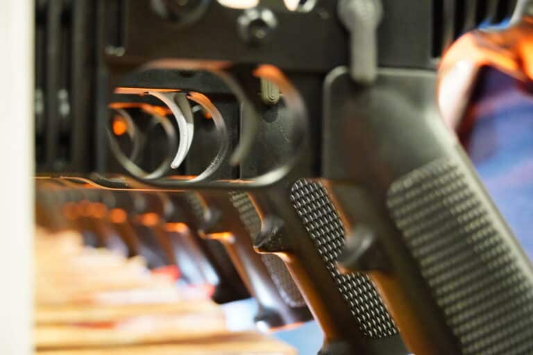 A line of AR-15 triggers on display at Shot Show 2024
